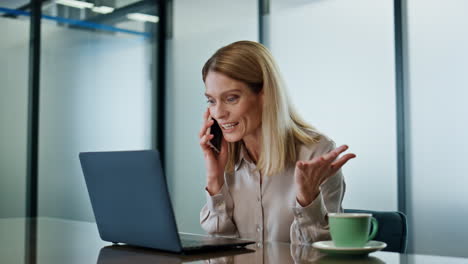 Excited-lady-rejoicing-smartphone-call-at-office-closeup.-Director-talking-phone