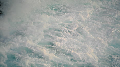 Sea-splashes-breaking-by-hill-outside-closeup.-Scenic-stormy-water-landscape