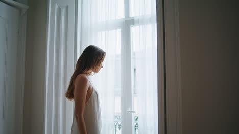 Sensual-girl-watching-window-bedroom-close-up.-Tender-woman-relaxing-at-morning