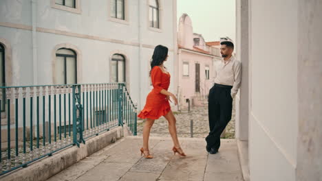 Woman-dancer-flirting-partner-starting-dance-near-railings.-Hot-couple-dancing.