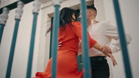 Couple-dancers-enjoy-latino-style-choreography-performing-near-street-railings.