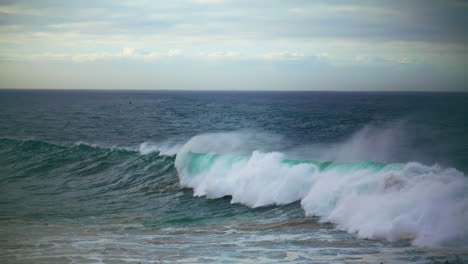 Large-waves-breaking-surf-on-drone-view.-Stormy-dark-ocean-rolling-seashore-in