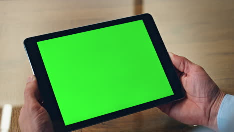 Closeup-chromakey-tablet-man-hands-hold-in-office.-Ceo-using-green-screen-device
