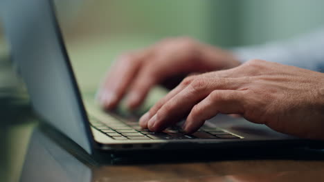 Businessman-hands-working-computer-keyboard-indoors-close-up.-Boss-typing-laptop