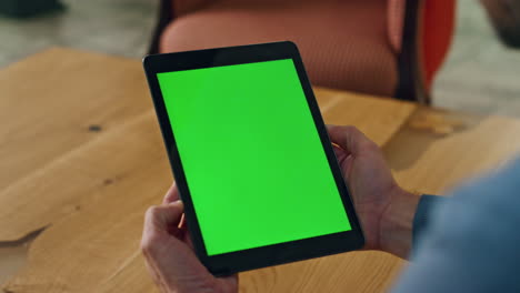 Greenscreen-pad-manager-hands-holding-office-close-up.-Man-reading-mockup-screen