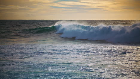 Powerful-ocean-surf-rolling-seashore-on-sunny-morning.-Slow-motion-huge-waves
