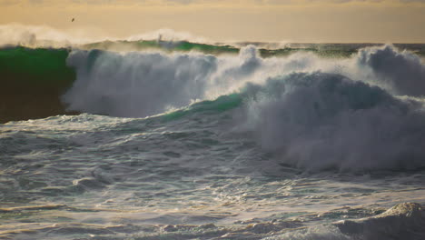 Dramatic-stormy-ocean-waves-splashing-on-sunny-day.-Extreme-seashore-landscape