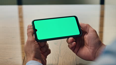 Manager-hands-using-chromakey-smartphone-office.-Unknown-employee-looking-phone