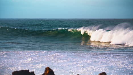 Massive-sea-wave-swelling-in-slow-motion.-White-foaming-ocean-rolling-towards