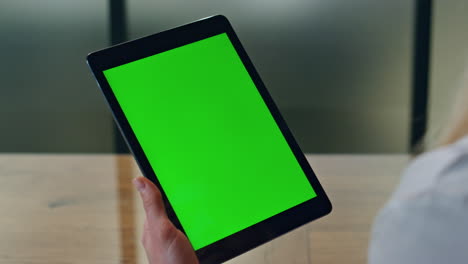 Lady-finger-tapping-mockup-tablet-indoor-closeup.-Woman-holding-chromakey-pad