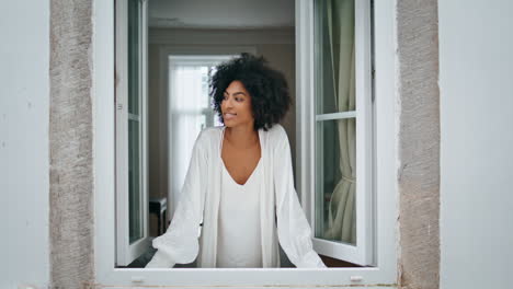 African-woman-looking-window-home-closeup.-Relaxed-lady-enjoying-rainy-morning