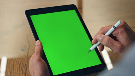 Designer-hand-drawing-greenscreen-tablet-office-closeup.-Artist-using-chroma-pad