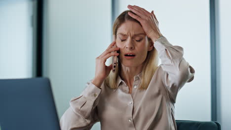 Annoyed-business-woman-calling-phone-at-work-desk-closeup.-Angry-ceo-facepalming