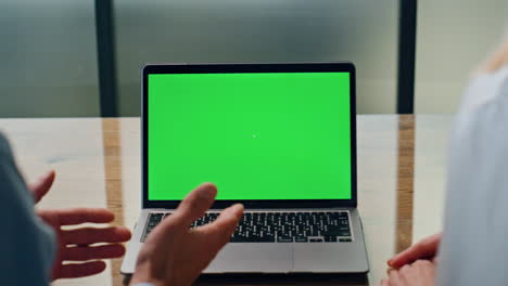 Businessman-gesturing-hands-at-greenscreen-laptop-call.-Colleagues-videocalling