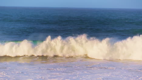 Morning-ocean-wave-rolling-towards-shallow-in-super-slow-motion.-White-sea-foam