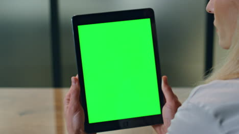 Greenscreen-pad-woman-hands-holding-at-office-close-up.-Lady-watching-computer