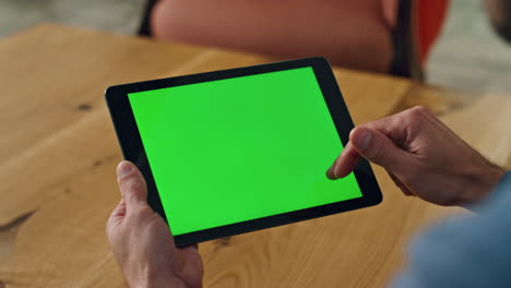 Man-finger-swiping-greenscreen-tablet-office.-Close-up-specialist-scrolling-tab