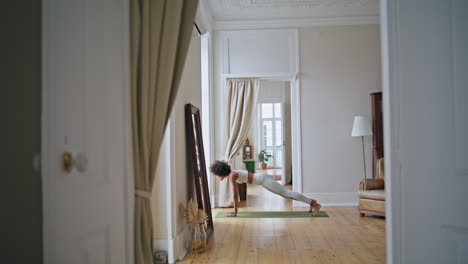 Flexible-lady-training-yoga-house.-African-american-woman-practicing-gymnastic
