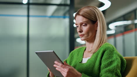 Thoughtful-manager-working-tablet-office-closeup.-Focused-woman-using-computer