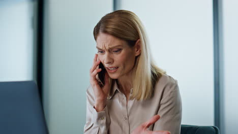 Nervous-manager-shouting-smartphone-at-work-closeup.-Furious-woman-arguing-call