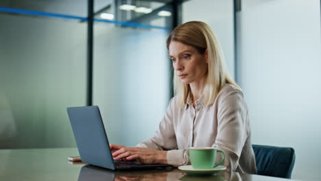 Focused-businesswoman-texting-laptop-at-office-closeup.-Woman-working-computer