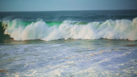 Dangerous-ocean-waves-foaming-on-summer-morning.-Huge-surf-rolling-to-shallow