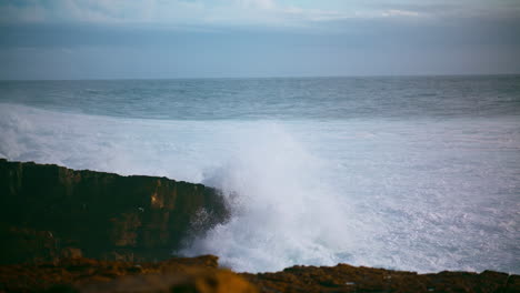 Beautiful-waves-crashing-rocky-shore.-Foaming-sea-washing-hitting-wild-coastline