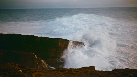 Coastal-waves-hitting-stones-on-stormy-day.-Powerful-ocean-rolling-hitting-beach