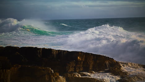 Huge-waves-breaking-rocky-beach-in-super-slow-motion.-Powerful-sea-surf-rolling