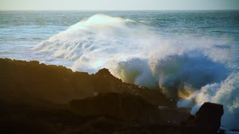 Dramatic-ocean-rolling-coastline-at-sunrise-slow-motion.-Powerful-foaming-waves