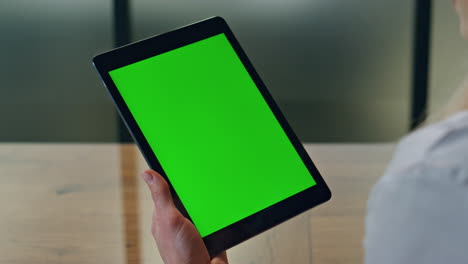 Manager-finger-touching-greenscreen-tablet-at-office.-Woman-using-chromakey-tab