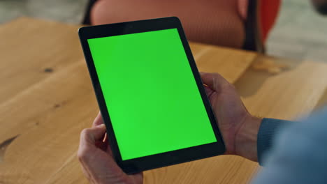Man-watching-chromakey-tablet-at-table-closeup.-Anonymous-lawyer-reading-email