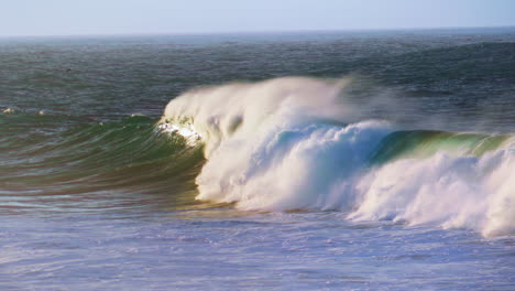 Slow-motion-breaking-surf-rolling-towards-coast.-Powerful-foamy-waves-crashing