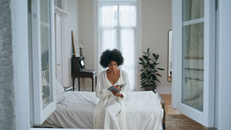 Gentle-lady-reading-book-luxury-bedroom.-Black-hair-girl-holding-favourite-novel