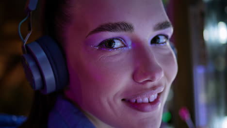 Woman-modern-bright-makeup-looking-camera-closeup.-Portrait-girl-in-headphones.