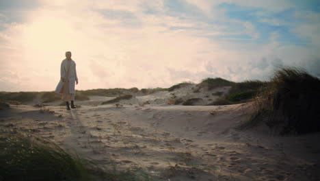 Serene-woman-walking-sand-dunes.-Calm-model-silhouette-enjoying-seaside-morning