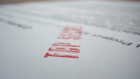 Closeup-classified-paper-document-with-stamp-top-secret.-Macro-confidential-text