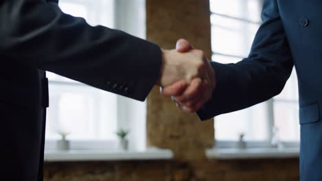 Business-men-shaking-hands-after-successful-signing-contract-in-office-close-up.