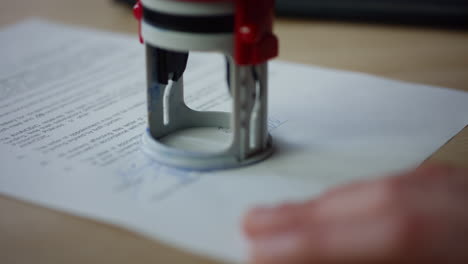 Man-hands-signing-document-putting-seal-close-up.-Writing-signature-on-paper.