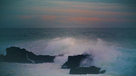 Storm-ocean-hitting-coastal-rocks-at-dark-skyline.-Breathtaking-evening-seascape