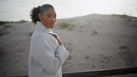 Pensive-woman-strolling-sand-beach-dunes.-Peaceful-african-american-thinking