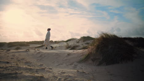 Lonely-woman-walking-sand-dunes.-Dreamy-tourist-enjoying-weekend-trip-outdoors.