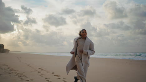 Serious-woman-running-beach-on-cloudy-day.-Worried-stressed-model-leaving-shot
