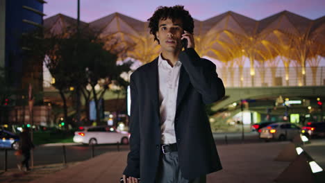 Business-man-having-phone-call-at-night-lights-street.-Manager-carrying-baggage