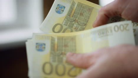 Businessman-hands-counting-profit-close-up.-Unknown-man-calculating-euro-cash.