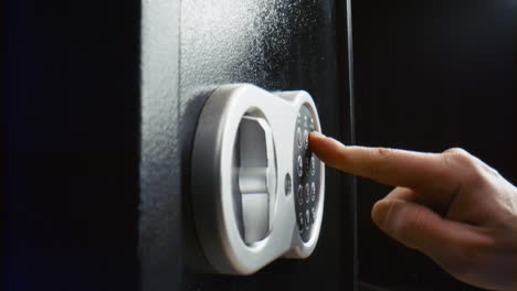 Hand-closing-strongbox-door-closeup.-Person-entering-combination-to-lock-safe.