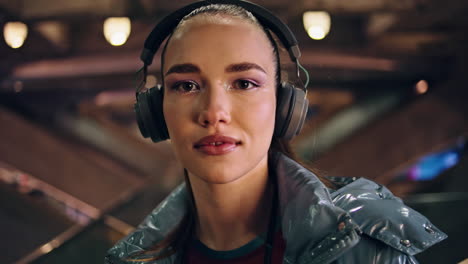 Gorgeous-woman-wearing-headphones-looking-camera-close-up.-Girl-listening-music.