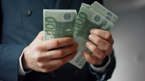 Closeup-hands-calculating-banknotes-euro.-Man-counting-european-currency-cash.