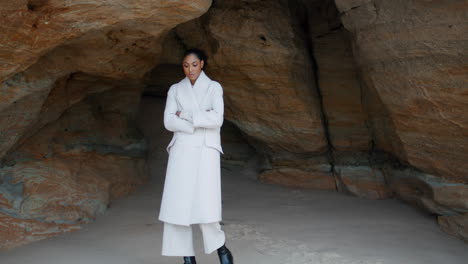 Worried-african-american-walking-seashore-cave.-Lonely-calm-woman-contemplating