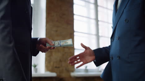 Businessman-giving-money-partner-at-office-meeting-close-up.-Man-receiving-bribe
